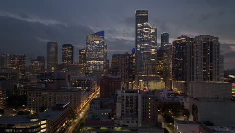 Trucking-Drone-shot-of-Downtown-Houston-at-night