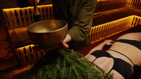 sound healing session in sauna with fir branches