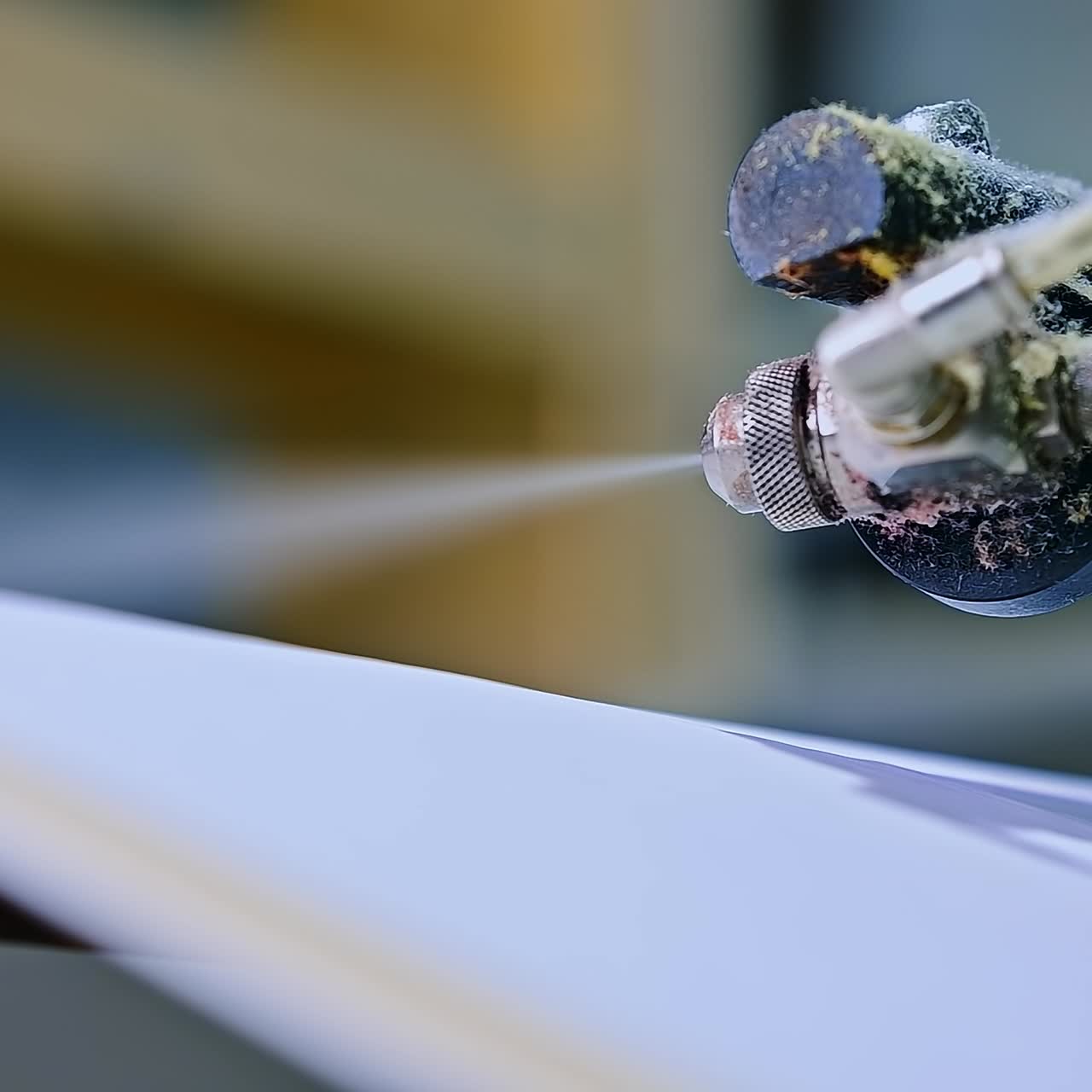 Diapers manufacturing plant. Special mechanism spraying the layer. Close up