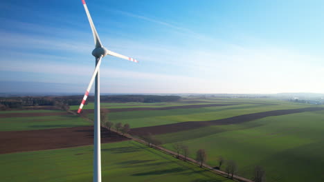 wind turbine propeller rotating over rural fields