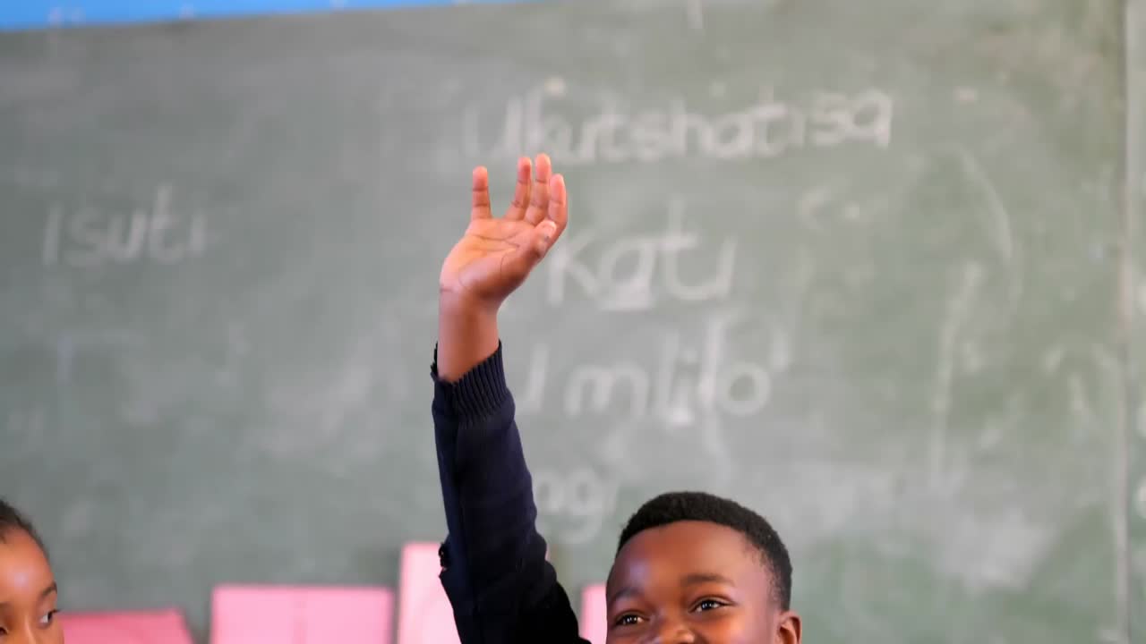 Schoolkid hand raised in the classroom 4k
