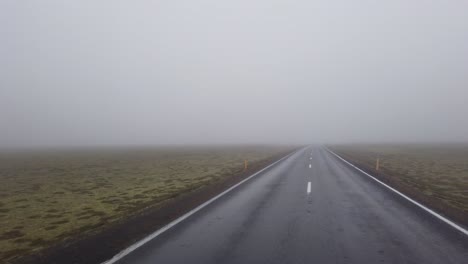 desolated highway part of icelandic ring road in covered in fog