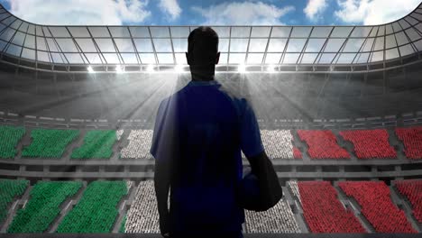 Animation-of-rear-view-of-football-player-holding-ball-over-italian-flag-in-sports-stadium