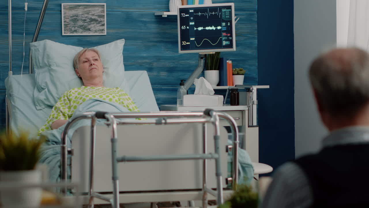 Senior woman laying in hospital bed at nursing facility