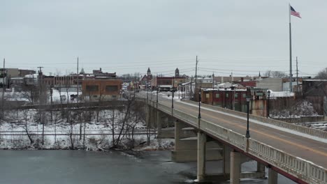 ascend and fly over main road and bridge of small american town