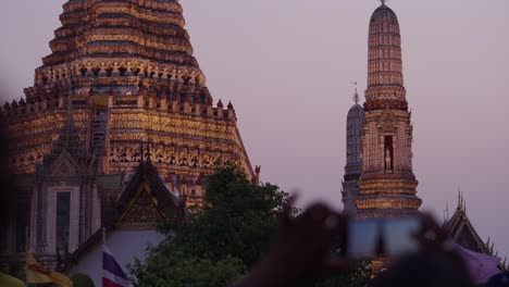 taking photo of wat arun at sunset