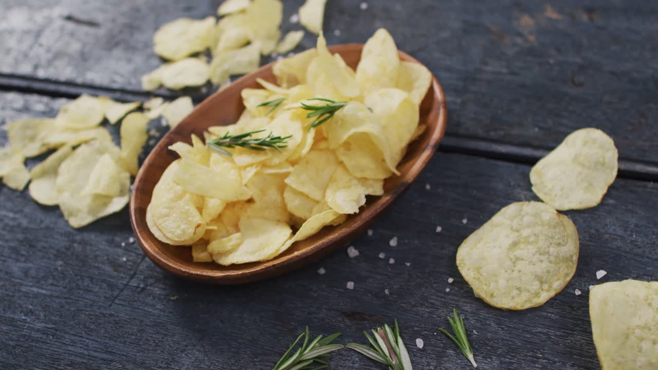 Close up view of potato chips in a bowl with copy space on wooden surface