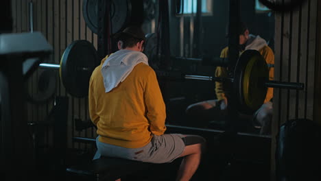 man praying on gym bench between intense bench press sets