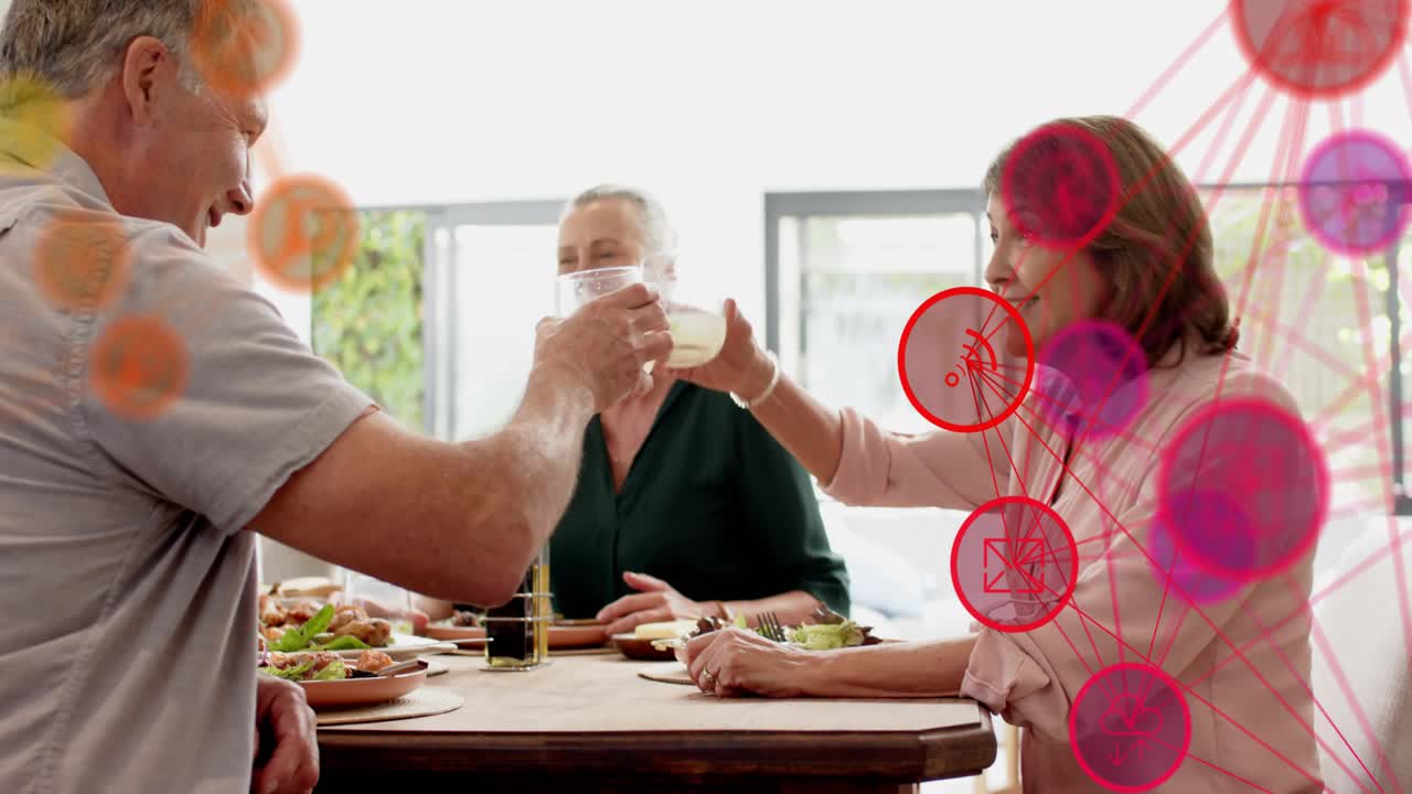 Left man speaking, others gesturing and clinking glasses to toast at meal, nodes overlaying right