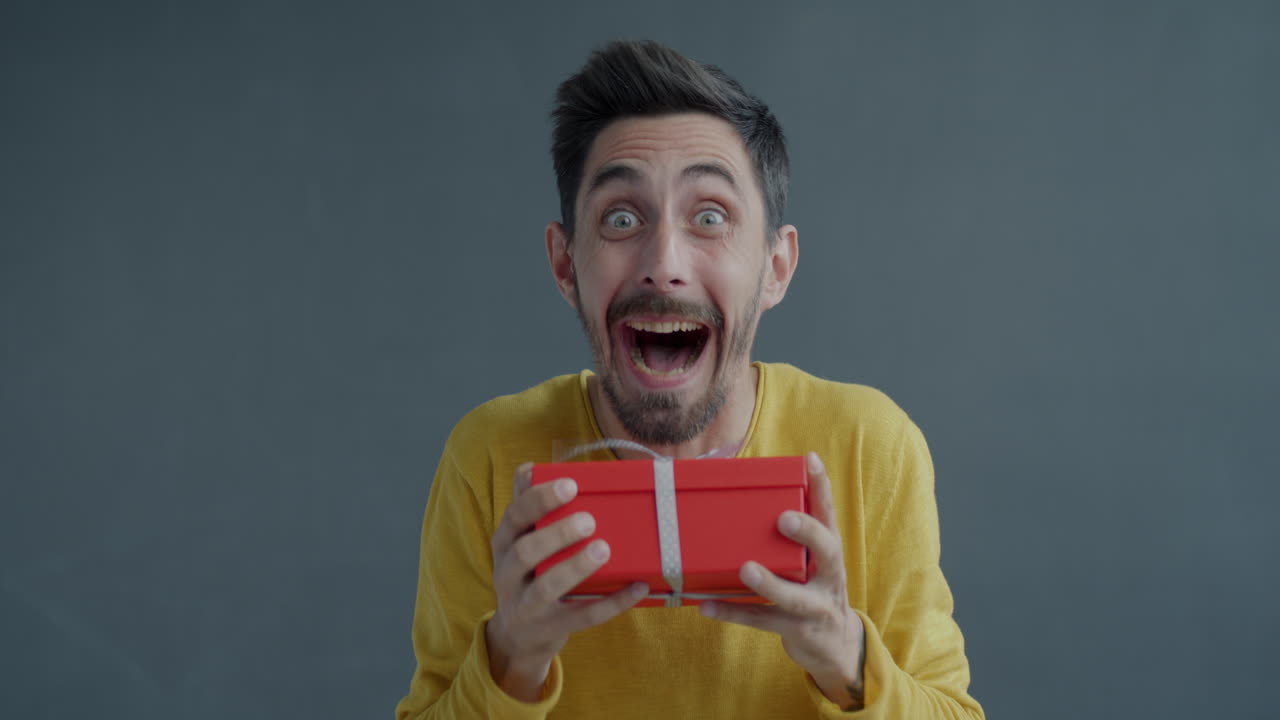 Man Excitedly Holding a Gift