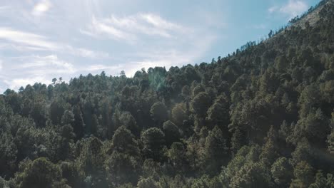 Drone-Aerial-view-of-beautiful-green-forest-and-clouds-moving-with-the-wind-in-Acatenango-volcano,-Guatemala