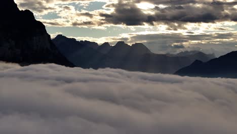 majestic mountain peaks above a sea of clouds at sunrise