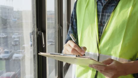 engineers are investigating problems during construction. inspection engineers use pencils to write down the problem areas and write problem on check sheet for fix. concept of structural inspection