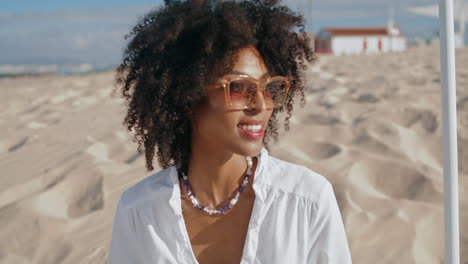 stylish woman enjoy beach on sunny day closeup vertical. happy african american