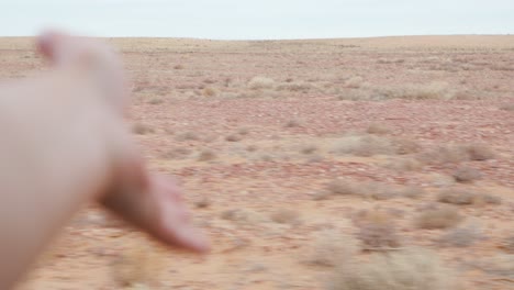 hand out of car window, dusty outback landscape