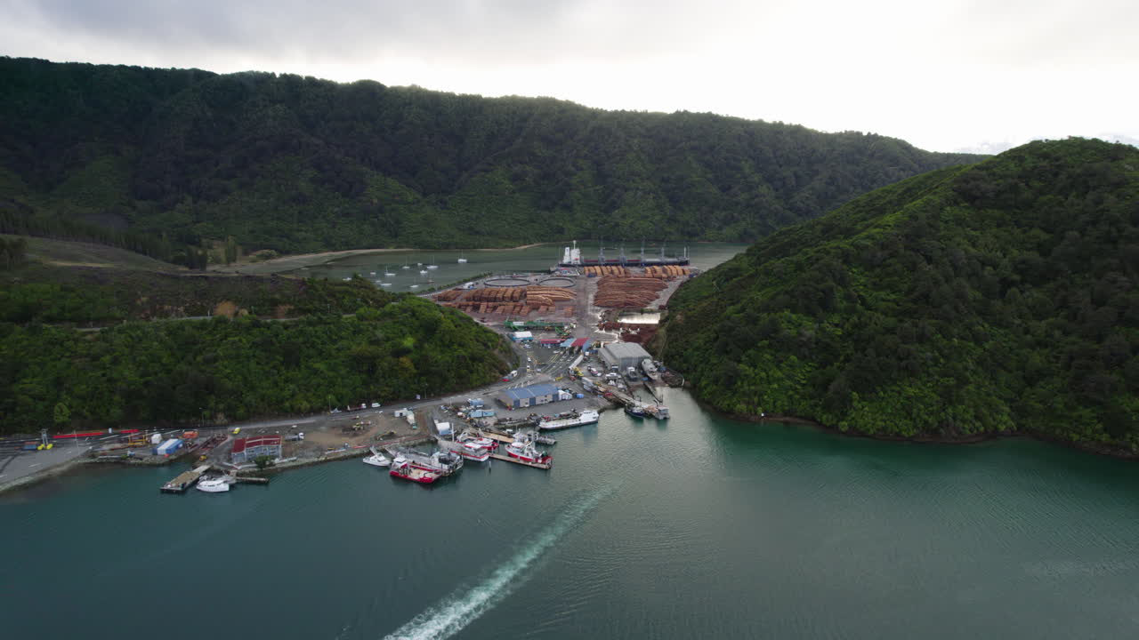 Drone shot approachjng of the Waimahara log Wharf, cloudy day in Picton, NZ