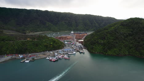 drone shot approachjng of the waimahara log wharf, cloudy day in picton, nz