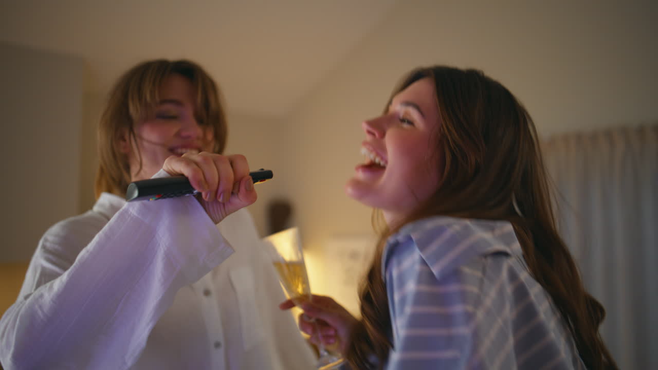 Laughing women partying home at night hen party closeup. Joyful girls in pajamas