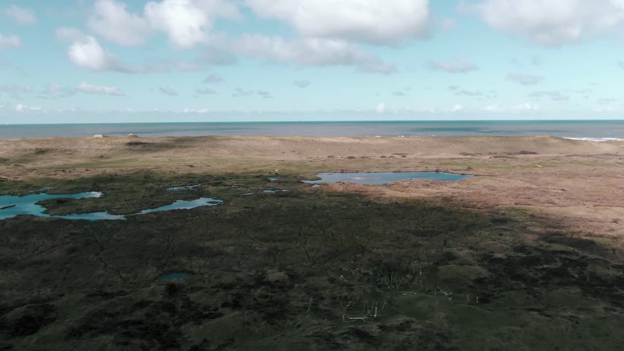 Offshore Marshland At Sand Dune Ocean In Texel Island During Sunny Day In Netherland. - Aerial Shot