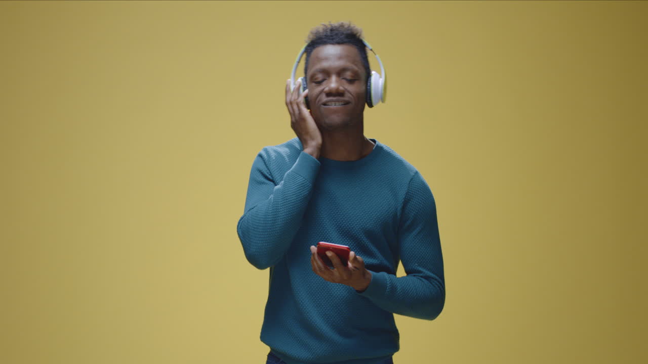 Man listening to music with headphones and smartphone