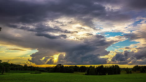 Epic-sunlight-rays-pierce-through-clouds-in-bursts-above-countryside-hdr-field,-time-lapse