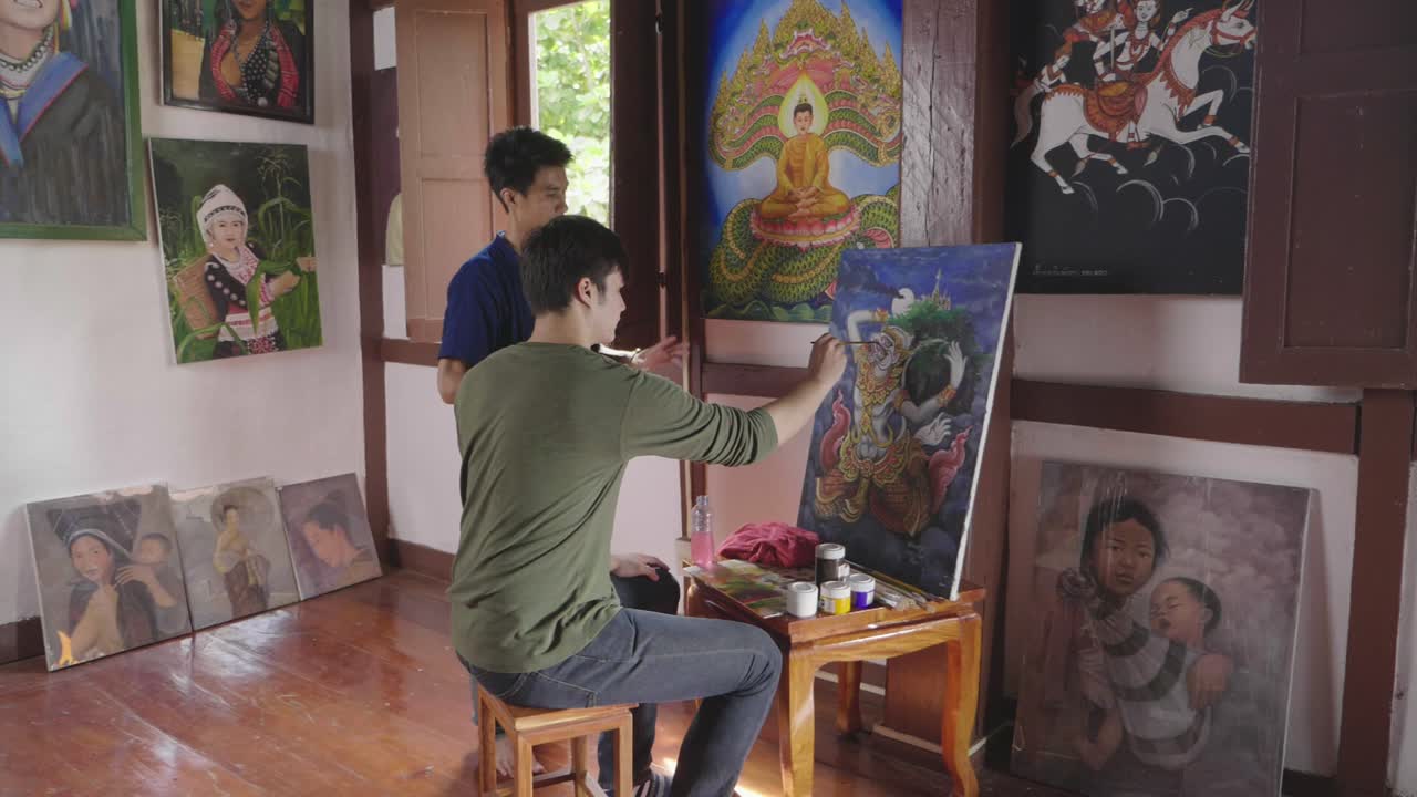 Young Man Painting In Art Studio With His Teacher, Slow Motion