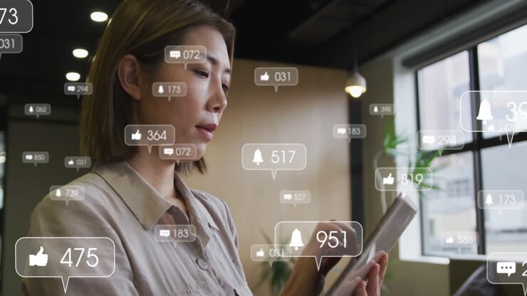 Animation of media icons over asian businesswoman in office