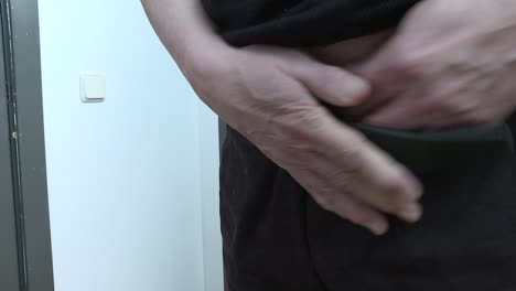 man putting on pants