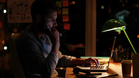 casual businessman using laptop at night