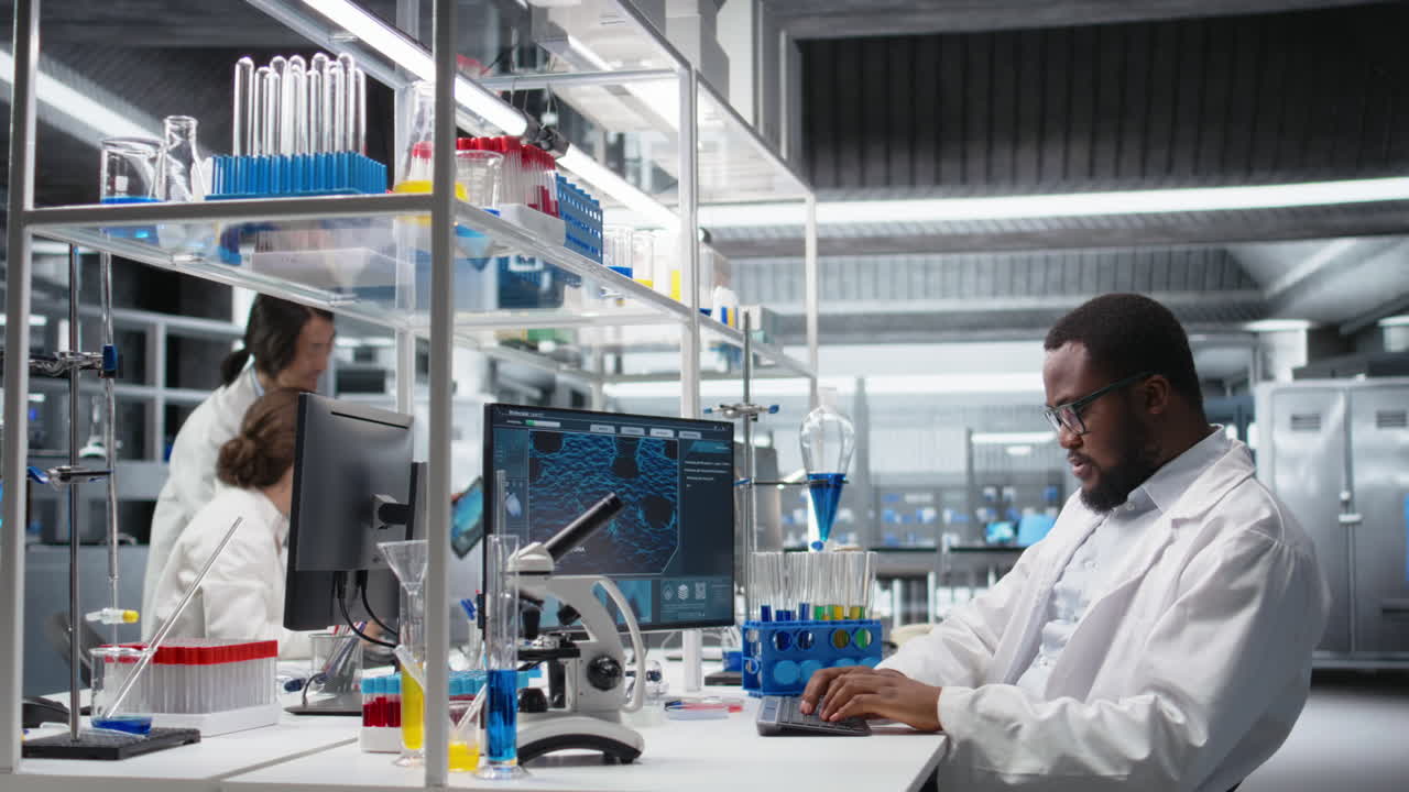 Vertical video Lab technician at desk typing on PC keyboard, doing research tasks