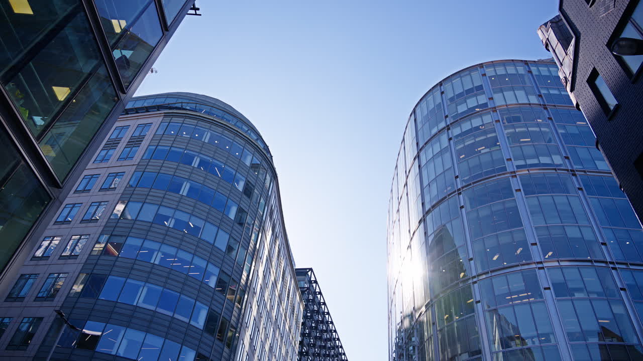 View of modern glass office buildings in London, England with sunlight reflecting off windows. Primrose Street
