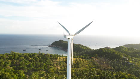 windmill on a tropical island by the ocean coast on a beautiful clear day, aerial