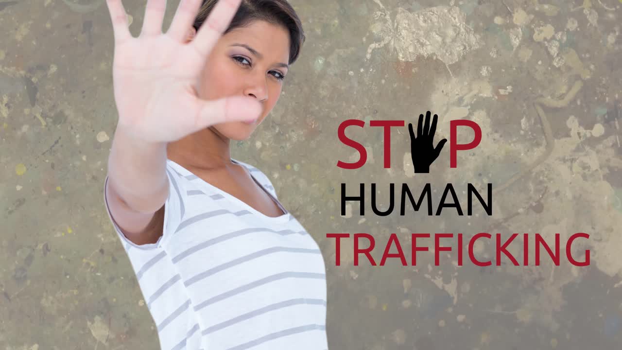 Animation of stop human trafficking text over biracial woman with stop gesture