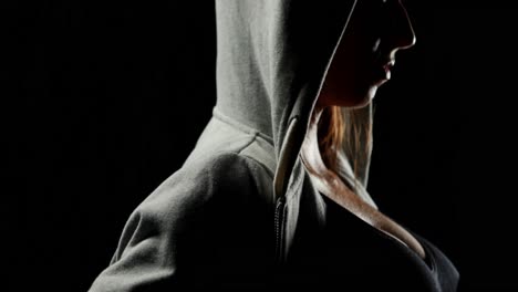 muscular woman wearing grey hood