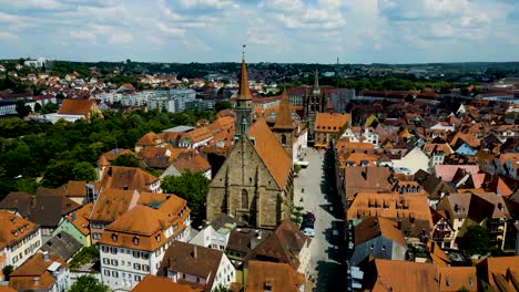 4k aerial drone video of the st. johannis kirche church and kirche st. gumbertus church in downtown ansbach, germany