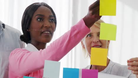 businesspeople interacting over sticky notes