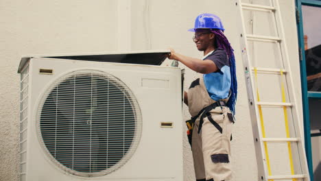 repairman working on air conditioner