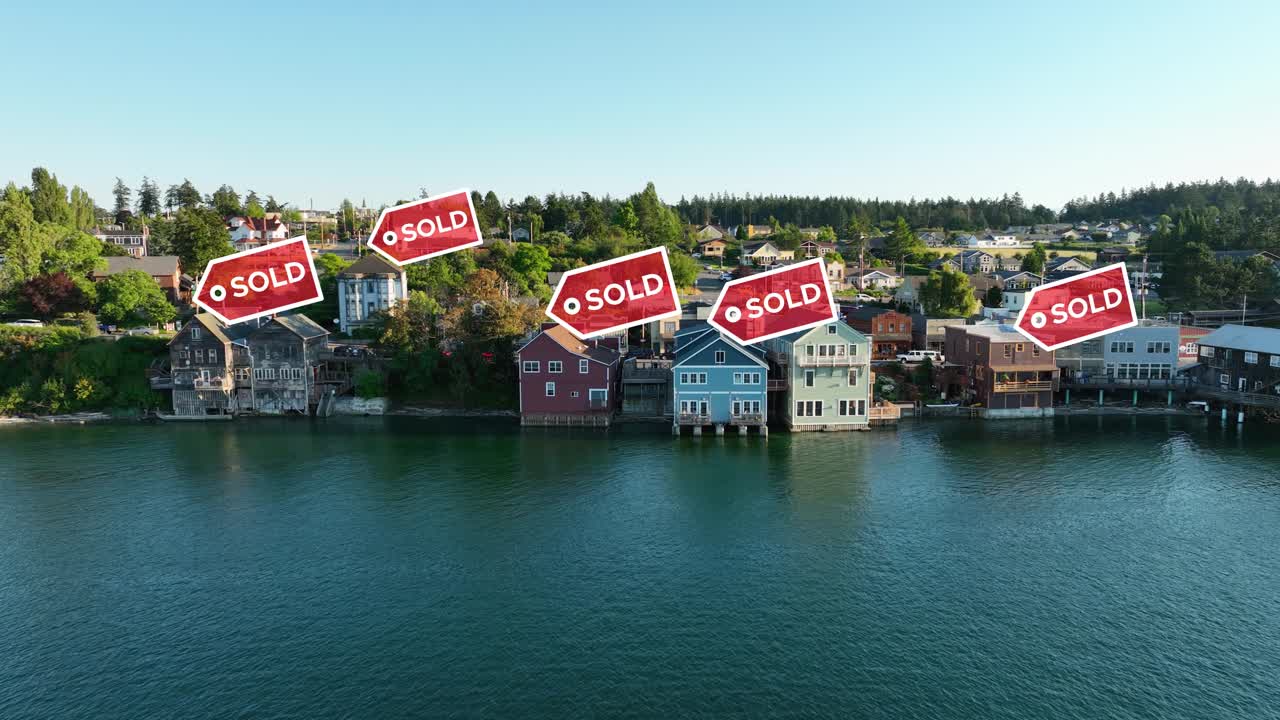 Aerial view pushing towards waterfront properties with &amp;quot;SOLD&amp;quot; signs appearing above them