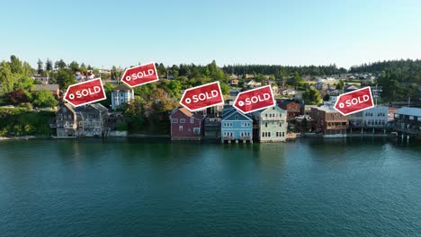 aerial view pushing towards waterfront properties with "sold" signs appearing above them