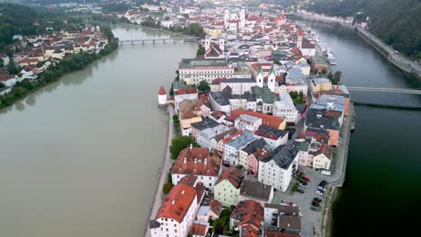 drone flight over river inn and river danube with city centre in passau, germany with distinctive colours of both rivers, danube the deep blue, and muddy inn