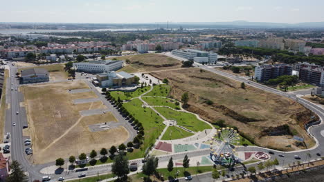 aerial flight over seixal landscape in portugal during sunny day with park and housing area