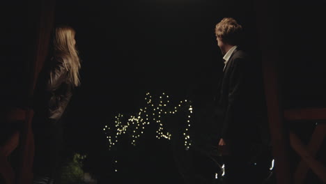 couple on a bridge at night