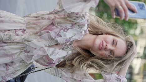 woman in floral dress taking a selfie