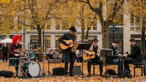 a captivating outdoor music performance amidst autumn's vibrant foliage: musicians engaged in an inspiring jam session, bringing melodies to life in a scenic setting