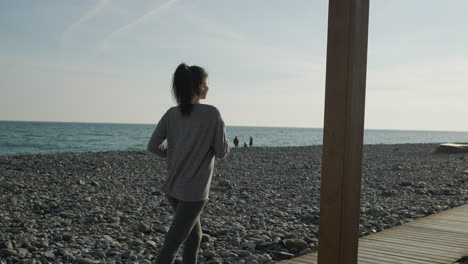 woman running on a beach path