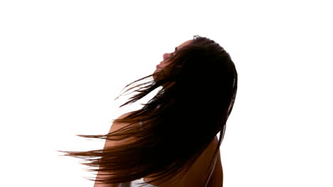 woman shaking her black hair and turning around