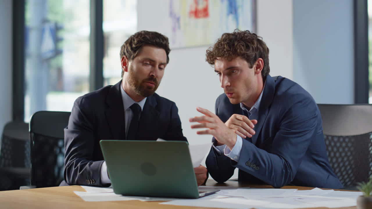 Business partners planning project at meeting closeup. Colleagues looking laptop