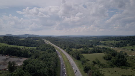 aerial crane hyperlapse shot revealing fast traffic on interstate 40 in north carolina with afternoon clouds