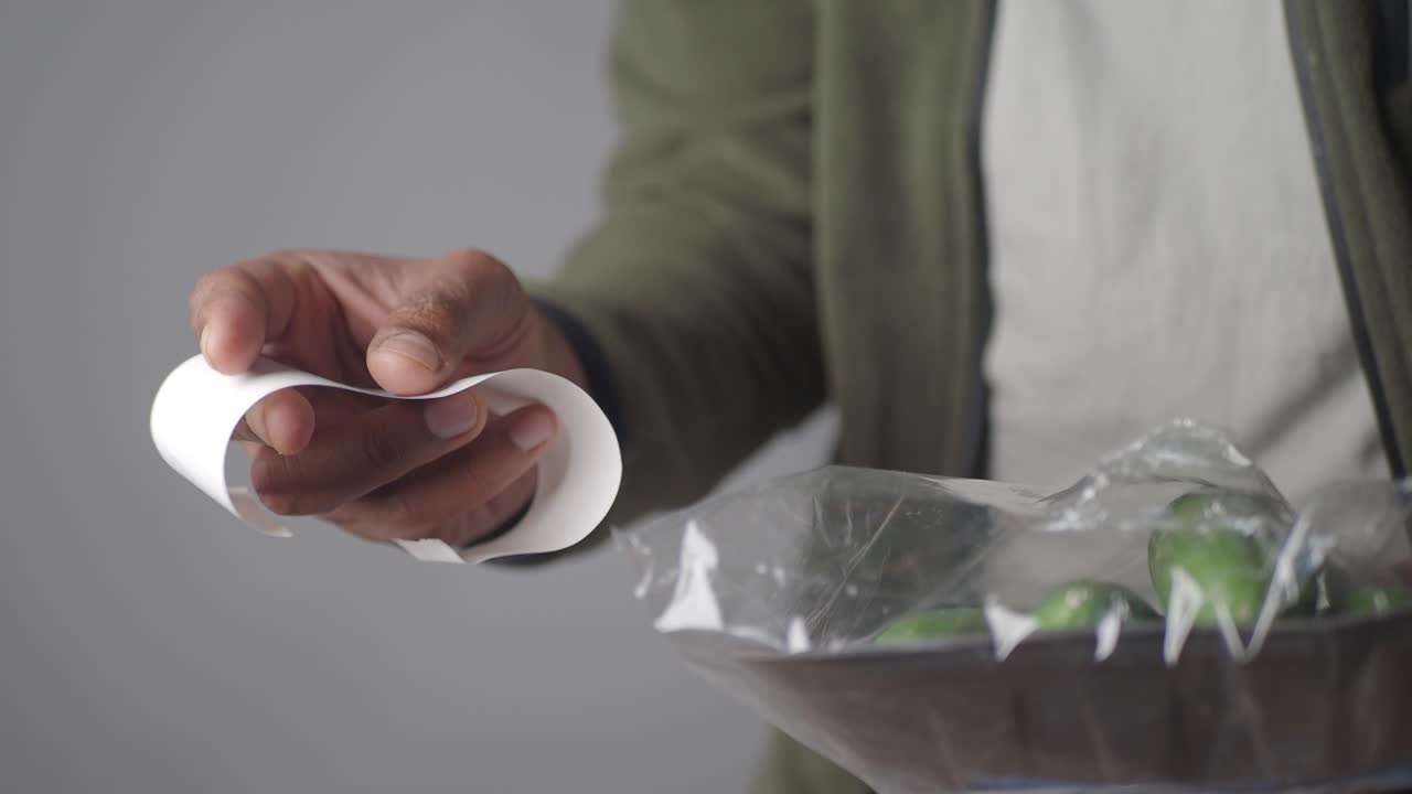 Customer Receiving a Grocery Receipt