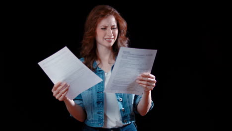 a young caucasian woman looks at documents, confused